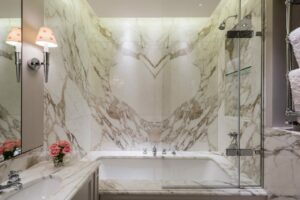 A dramatic pattern with a book matched marble bathroom project.