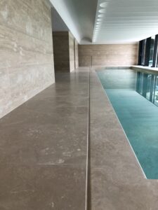 Travertine marble poolside natural stone.